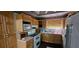 Kitchen featuring wooden cabinets, double oven and standard appliances at 17932 Wendy Sue Ave, Hudson, FL 34667