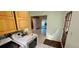 Laundry room features washer, dryer, storage cabinets, door to outside, and tile flooring at 17932 Wendy Sue Ave, Hudson, FL 34667