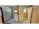 Bright laundry area with a washer, dryer, cabinetry, and adjacent tiled bathroom at 17932 Wendy Sue Ave, Hudson, FL 34667