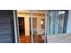 Looking through a sliding glass door showing wood floors and three access doors at 17932 Wendy Sue Ave, Hudson, FL 34667