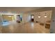 Open living room with tile flooring, chandelier lighting, and backyard access at 17932 Wendy Sue Ave, Hudson, FL 34667