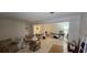 Spacious living room area with tile flooring, ample natural light, and room for customization and personalization at 17932 Wendy Sue Ave, Hudson, FL 34667