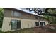 View of the rear exterior of the house with multiple sliding glass doors and horizontally siding at 17932 Wendy Sue Ave, Hudson, FL 34667