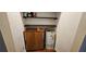 A utility closet with a water heater, shelving and a cabinet at 17932 Wendy Sue Ave, Hudson, FL 34667