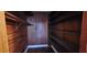 Walk-in closet with wood paneling, shelving, and ample storage space at 17932 Wendy Sue Ave, Hudson, FL 34667