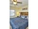 Comfortable bedroom showcasing a wooden headboard, patterned bedding, and window views at 20857 Haulover Cv # B15, Lutz, FL 33558