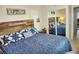 Well-decorated bedroom highlighting a wooden headboard, patterned bedding and sliding closet at 20857 Haulover Cv # B15, Lutz, FL 33558