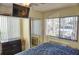Relaxing bedroom with a mounted TV, view to window, neutral colors and ample storage at 20857 Haulover Cv # B15, Lutz, FL 33558