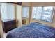 Comfortable bedroom featuring a large window for natural light and a mirrored closet at 20857 Haulover Cv # B15, Lutz, FL 33558