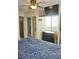 Bright bedroom with sliding closet doors, mounted TV, dresser and a view to other rooms at 20857 Haulover Cv # B15, Lutz, FL 33558