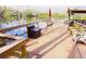 Waterfront dock featuring chairs, benches, and an umbrella overlooking the calm lake and wooded landscape at 20857 Haulover Cv # B15, Lutz, FL 33558