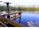 The dock provides views of the lake where nature meets a serene and relaxing setting at 20857 Haulover Cv # B15, Lutz, FL 33558