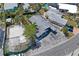 Aerial view of a single-Gathering home with a spacious parking area and adjacent lot, plus lush landscaping at 291 115Th Ave, Treasure Island, FL 33706