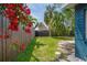 Private backyard with lush greenery, wooden fence, and tropical landscaping at 291 115Th Ave, Treasure Island, FL 33706