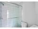 Modern bathroom featuring a glass-enclosed shower with wave tile and pebble floor at 291 115Th Ave, Treasure Island, FL 33706