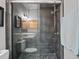 Modern bathroom with glass shower door, gray tile, and updated fixtures at 291 115Th Ave, Treasure Island, FL 33706