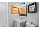 Clean bathroom with a gray vanity, matching mirror, and ample lighting at 291 115Th Ave, Treasure Island, FL 33706