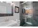 Modern bathroom featuring a glass-enclosed shower with gray tiles, a stylish vanity, and updated fixtures at 291 115Th Ave, Treasure Island, FL 33706