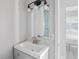Bathroom with a gray vanity, brushed nickel faucet, and modern lighting fixtures at 291 115Th Ave, Treasure Island, FL 33706
