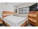 Cozy bedroom with stylish wood furniture, mini-split AC, and natural light from the window at 291 115Th Ave, Treasure Island, FL 33706