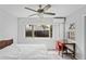 Bright bedroom with a ceiling fan, complemented by a cozy study area at 291 115Th Ave, Treasure Island, FL 33706