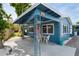 Charming blue single-story home with a covered porch and seating area at 291 115Th Ave, Treasure Island, FL 33706