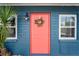 Charming front door with brick accents and a decorative wreath, creating a welcoming entrance at 291 115Th Ave, Treasure Island, FL 33706