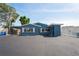 Charming blue home featuring white shutters, a carport, and ample parking space in front at 291 115Th Ave, Treasure Island, FL 33706