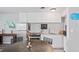 Charming eat-in kitchen with stainless steel appliances, white cabinetry, and a dining table at 291 115Th Ave, Treasure Island, FL 33706