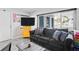 Cozy living room features a gray sofa, natural light from window, and modern decor at 291 115Th Ave, Treasure Island, FL 33706
