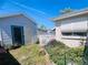 Cozy backyard featuring a storage shed, a white fence, and some flowering plants at 3243 Bayport Dr, Holiday, FL 34691