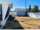 Wide view of backyard showing an old shed with a new fence at 3243 Bayport Dr, Holiday, FL 34691