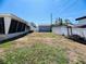 Fenced backyard featuring a detached garage, providing a private outdoor space at 3243 Bayport Dr, Holiday, FL 34691