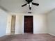 Bedroom featuring a ceiling fan, closet, and an attached room with tile flooring at 3243 Bayport Dr, Holiday, FL 34691