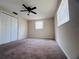 Bedroom with ceiling fan, neutral paint, window and closet at 3243 Bayport Dr, Holiday, FL 34691