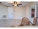 Bright dining area featuring a modern ceiling fan, tile flooring and access to an outside patio or lanai at 3243 Bayport Dr, Holiday, FL 34691
