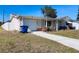Charming single-story home with a well-maintained lawn and tidy landscaping at 3243 Bayport Dr, Holiday, FL 34691