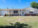 Charming single-story home with a well-maintained lawn and tidy landscaping at 3243 Bayport Dr, Holiday, FL 34691
