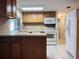 Well-lit kitchen featuring a kitchen island, modern appliances, and wood cabinetry at 3243 Bayport Dr, Holiday, FL 34691