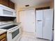 Bright kitchen featuring modern appliances and tile flooring, showcasing a refrigerator at 3243 Bayport Dr, Holiday, FL 34691
