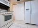 Bright kitchen featuring modern appliances and tile flooring, showcasing a refrigerator at 3243 Bayport Dr, Holiday, FL 34691
