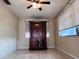 Living room area featuring tile floors, a decorative cabinet, and natural light from the window at 3243 Bayport Dr, Holiday, FL 34691