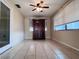 Open living room featuring tile floors, a ceiling fan, and a dark wood entertainment center at 3243 Bayport Dr, Holiday, FL 34691