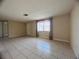 Bright living room featuring tile floors, natural light, and neutral wall paint at 3243 Bayport Dr, Holiday, FL 34691