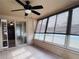 Enclosed sunroom features a ceiling fan, tile flooring, and multiple windows that provide ample natural light at 3243 Bayport Dr, Holiday, FL 34691