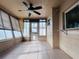 Enclosed sunroom features a ceiling fan, tile flooring, windows, and an exterior door with pet access at 3243 Bayport Dr, Holiday, FL 34691