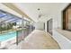 Expansive covered patio overlooking pool and lake, perfect for outdoor entertaining at 3255 Meadow View Ln, Palm Harbor, FL 34683