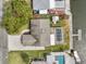 Aerial view of a home with a screened-in pool, dock, lush lawn, and paver driveway at 3328 Gulfview Dr, Hernando Beach, FL 34607