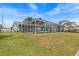 Spacious backyard featuring a screened-in pool and waterfront views at 3328 Gulfview Dr, Hernando Beach, FL 34607