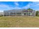 Fully screened pool area with lounge seating and backyard at 3328 Gulfview Dr, Hernando Beach, FL 34607
